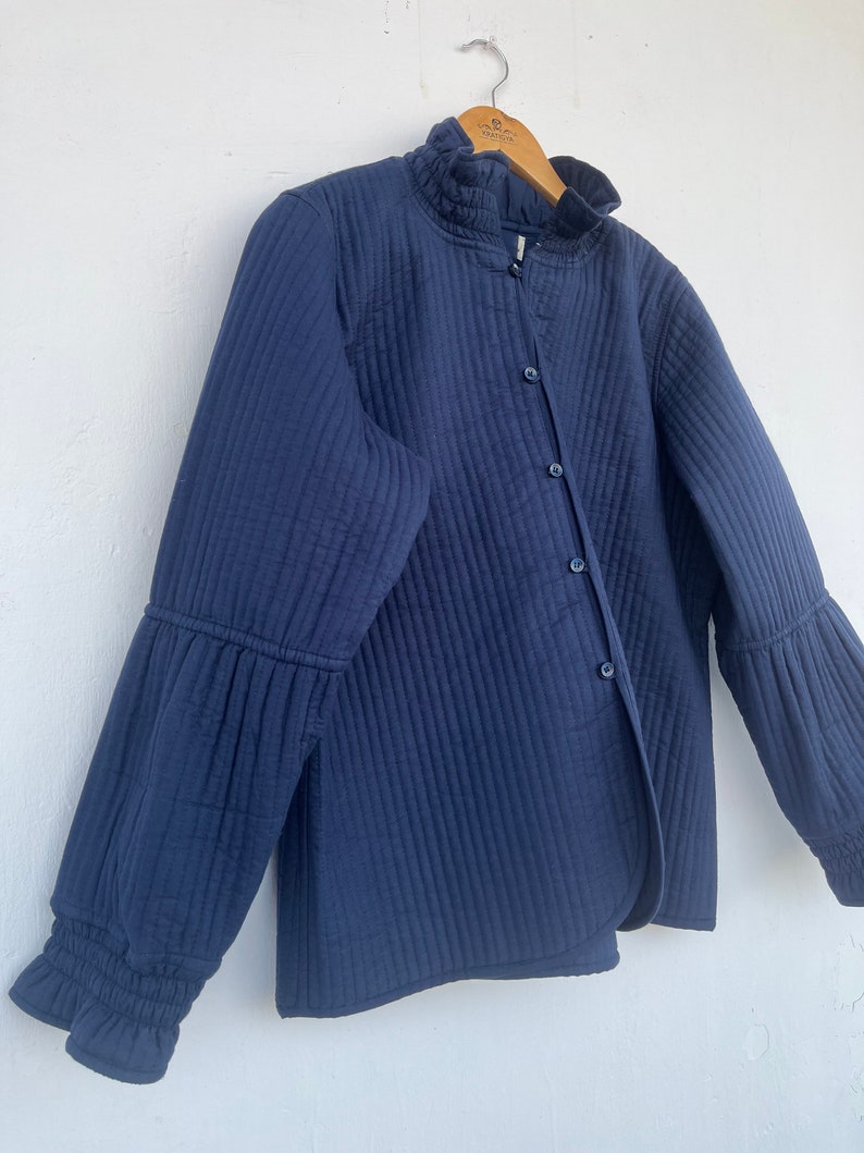 QUILTED cotton blue jacket with ruffle collar